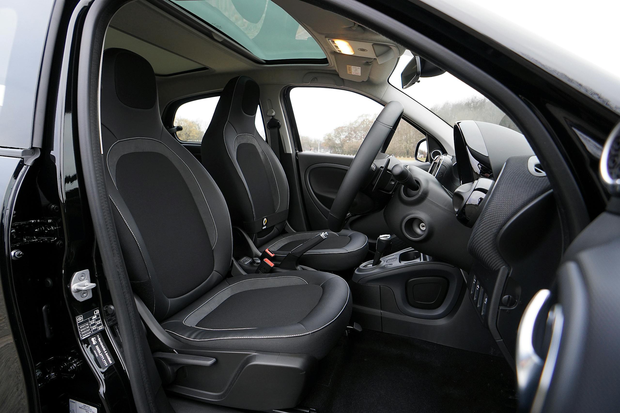 Explore a modern car's interior featuring black leather seats and advanced technology.